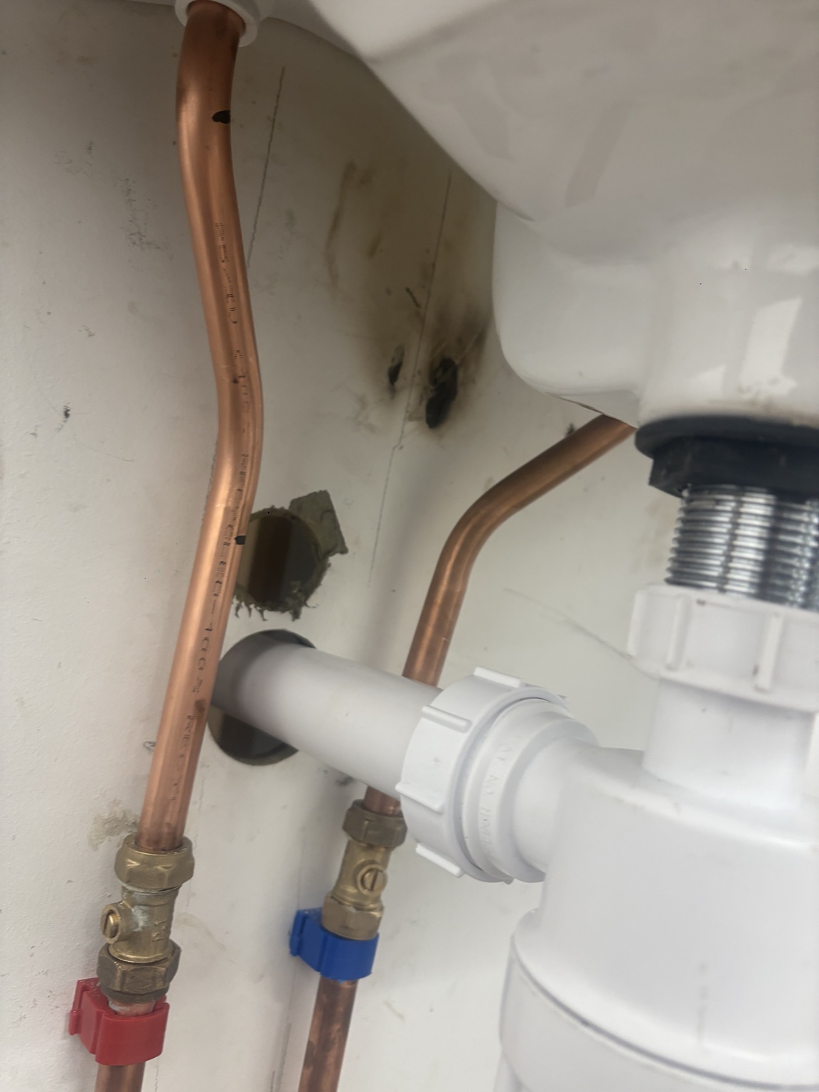 Copper pipework beneath a sink